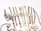 many different watches and bracelets laid out on a white surface