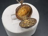 an image of a gold locke sitting on top of a white box