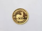 a close up of a gold coin with a skull on it