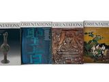 three books of oriental oriental art on display on a white surface