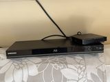a flat screen tv sitting on top of a bed