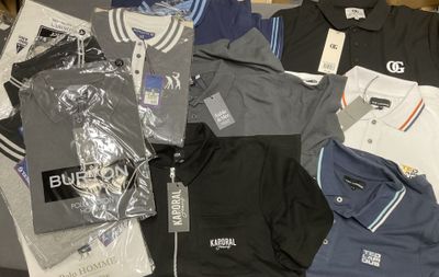 a lot of men ' s polo shirts that are on a table