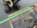 someone is measuring the width of a piece of wood on the ground
