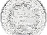 a close up of a silver coin with a wreath on it