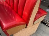 a red leather bench with a wooden seat on it