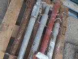 a pile of pipes on a pallet next to a pile of other pipes
