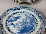 several blue and white plates are stacked on top of each other