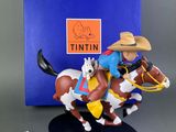 the figurine is of a cowboy on a horse with a hat on