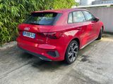 the rear end of a red audi car parked in a parking lot