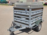 a small trailer that is parked in the parking lot