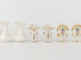 several different types of vases are lined up on a white surface