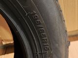 a close up of a tire on a wooden floor with a box in the background