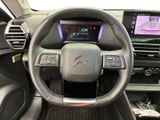 the interior of a car with a steering wheel and dashboard controls