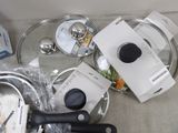 several pans and pans are sitting on a table next to a package of food