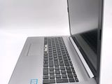 a laptop computer that is open on a white surface