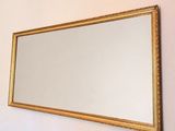 a mirror hanging on the wall in a room