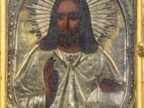 a gold and silver painting of jesus holding a cross