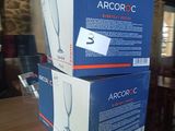 two boxes of empty wine glasses sitting on top of a wooden table