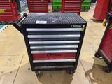 a close up of a tool box on a cart in a garage