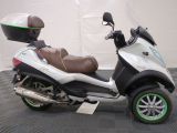 a motor scooter that is parked in a garage