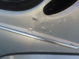 a close up of a car door handle with a stick sticking out of it