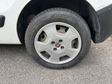 a white car with a flat tire on the street