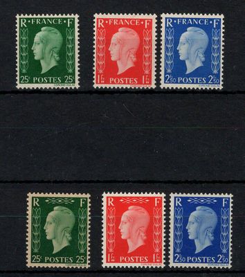 un groupe de quatre timbres de couleurs différentes sur un fond noir
