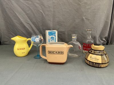 many different types of vases and pitchers on the table