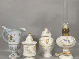 three vases, a lamp, and a vase on a table