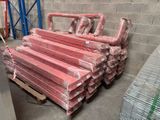 a pile of red pipes sitting on a pallet in a warehouse