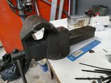 a workbench with tools on a table in a workshop
