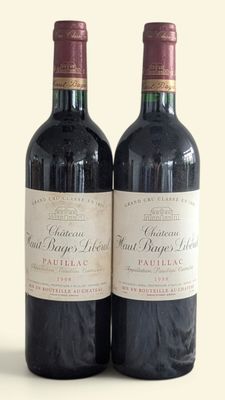 two bottles of wine sitting next to each other on a table