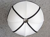 a white umbrella with a black ribbon around it