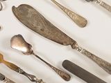 many different types of silverware on the table
