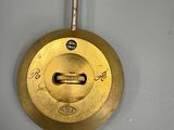 a clock that is hanging on the wall with a key