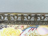 a picture of a gold plate with a rose on it
