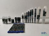 a lot of pens that are sitting on a table