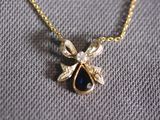gold plated necklace with a tear shaped sapphire stone and a gold chain