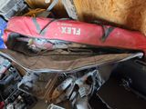 a red duffel bag sitting on top of a pile of luggage