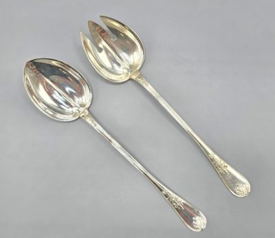 two silver spoons and a spoon on a gray surface