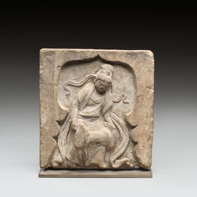 an image of a stone relief of a woman riding a horse