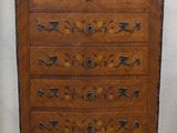 a wooden chest of drawers with a marble top