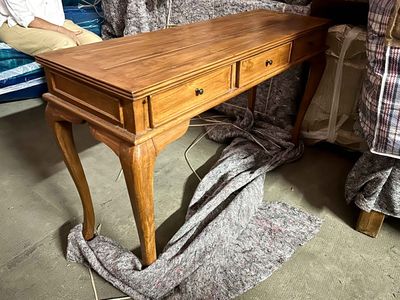 a wooden desk with a drawer on top of it