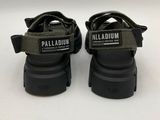 a pair of black sandals with a white label on the sole