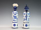 pair of blue and white porcelain figurines of a man and a woman