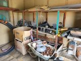 a wheelbarrow full of stuff in a garage