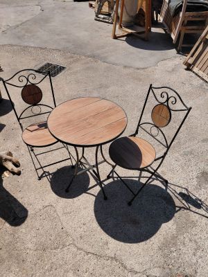 a dog that is standing next to a table and chairs