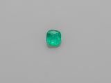 an emerald stone on a white surface