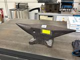 a table with an anvil on it in a workshop