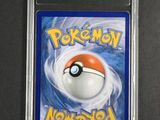a close up of a pokemon card on a black surface